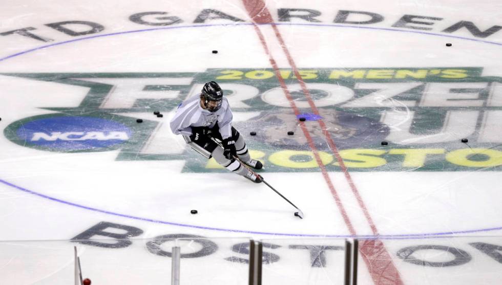 Providence's Kevin Rooney handles a puck during practice in Boston, Friday, April 10, 2015 in p ...