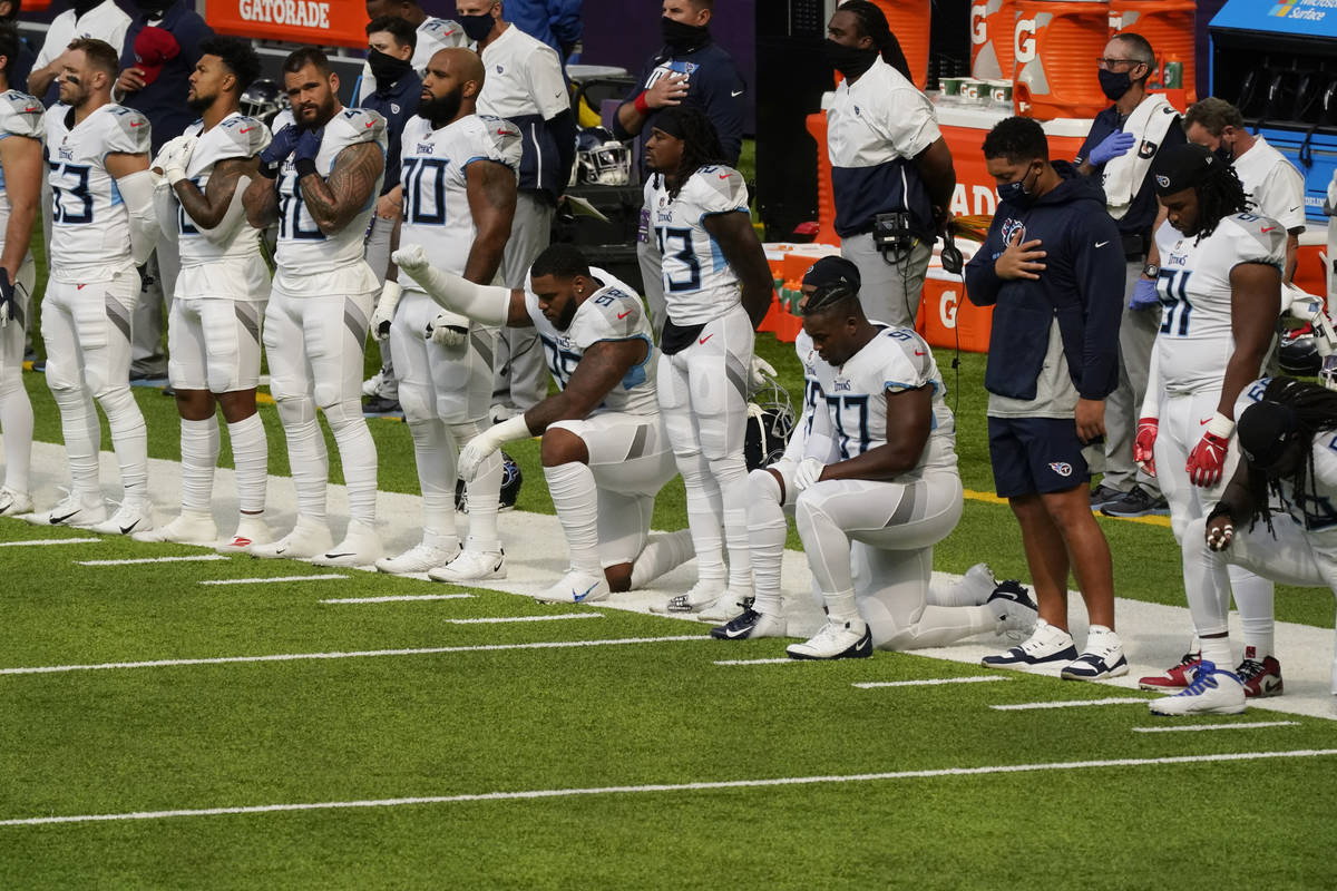 FILE - In this Sept. 27, 2020, file photo, members of the Tennessee Titans take part in the nat ...