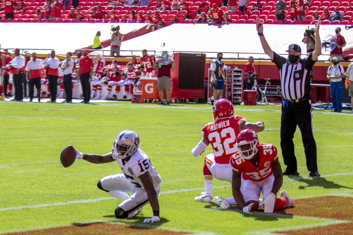 Las Vegas Raiders wide receiver Nelson Agholor (15) scores a touchdown against defenders Kansas ...