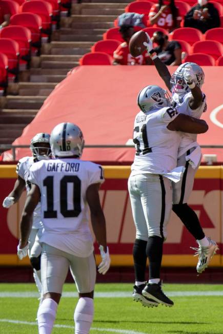 Las Vegas Raiders wide receiver Henry Ruggs III (11) celebrates his touchdown score with center ...
