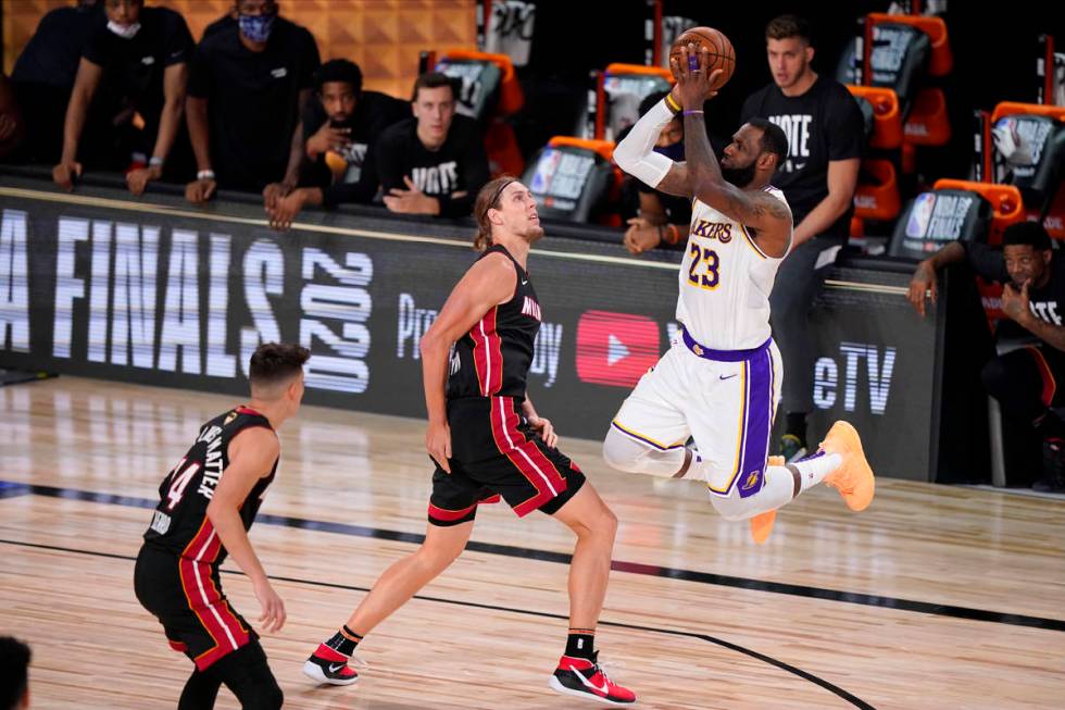 Los Angeles Lakers' LeBron James (23) takes a shot over Miami Heat's Kelly Olynyk (9) during th ...