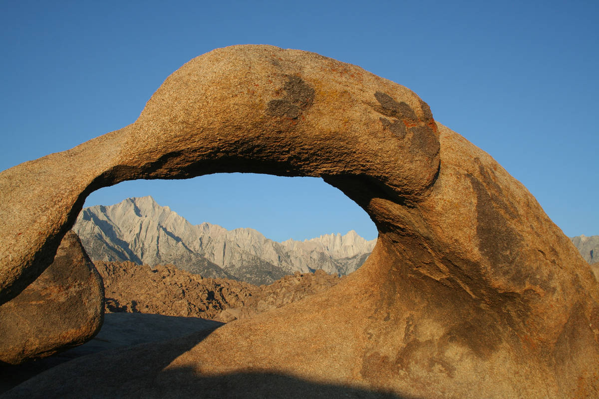 Mobius Arch frames Lone Pine Peak, left, at 12,949 feet, and Mount Whitney at 14,505 feet. (Deb ...
