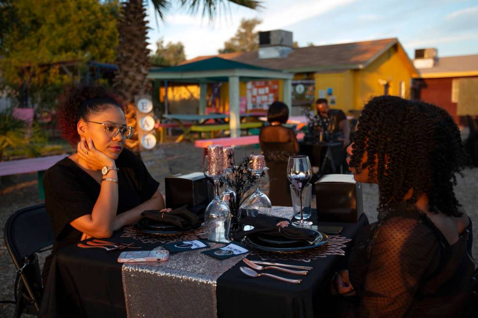 Krystal Derby listens as Najla Grant speaks before dinner at a Noir Culinary Experience event t ...