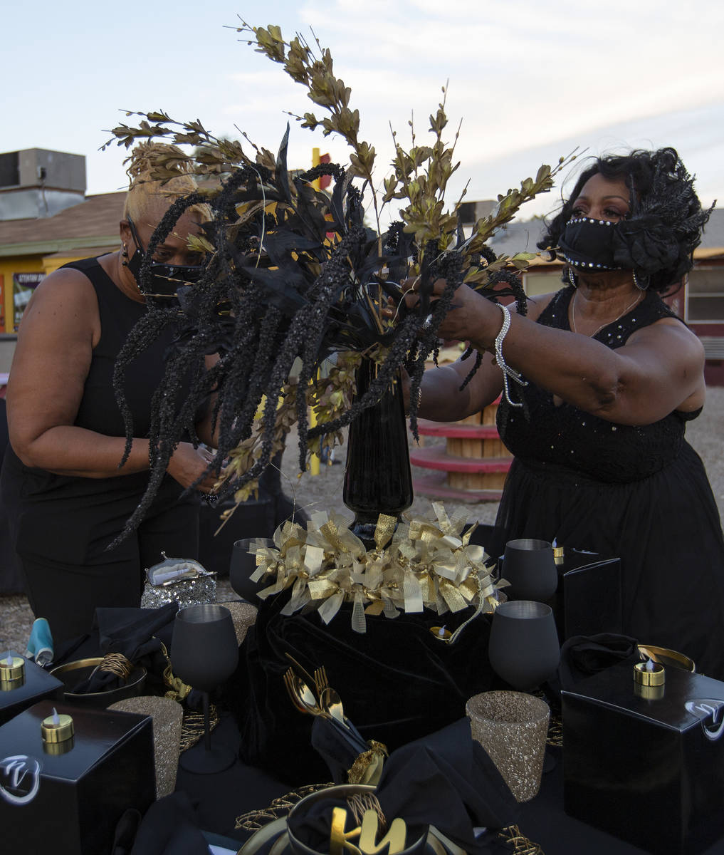 Lois Smith, left, and Verdale Quinney, right, perfect their table's decor before dinner at a No ...