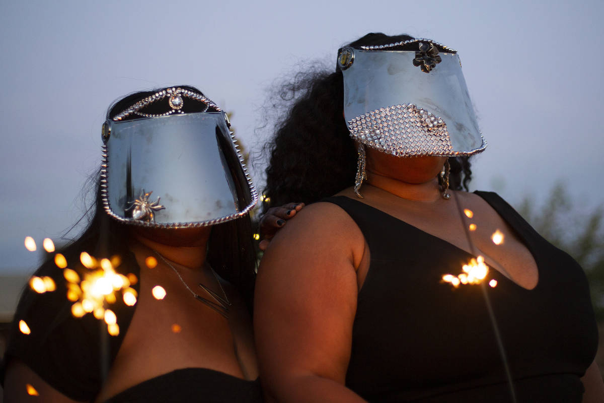 Kwazi Yimam and Monet Owens pose with their custom face shields at a Noir Culinary Experience e ...