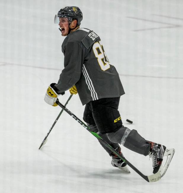 Vegas Golden Knights defenseman Nate Schmidt (88) jokes around carrying two sticks during pract ...