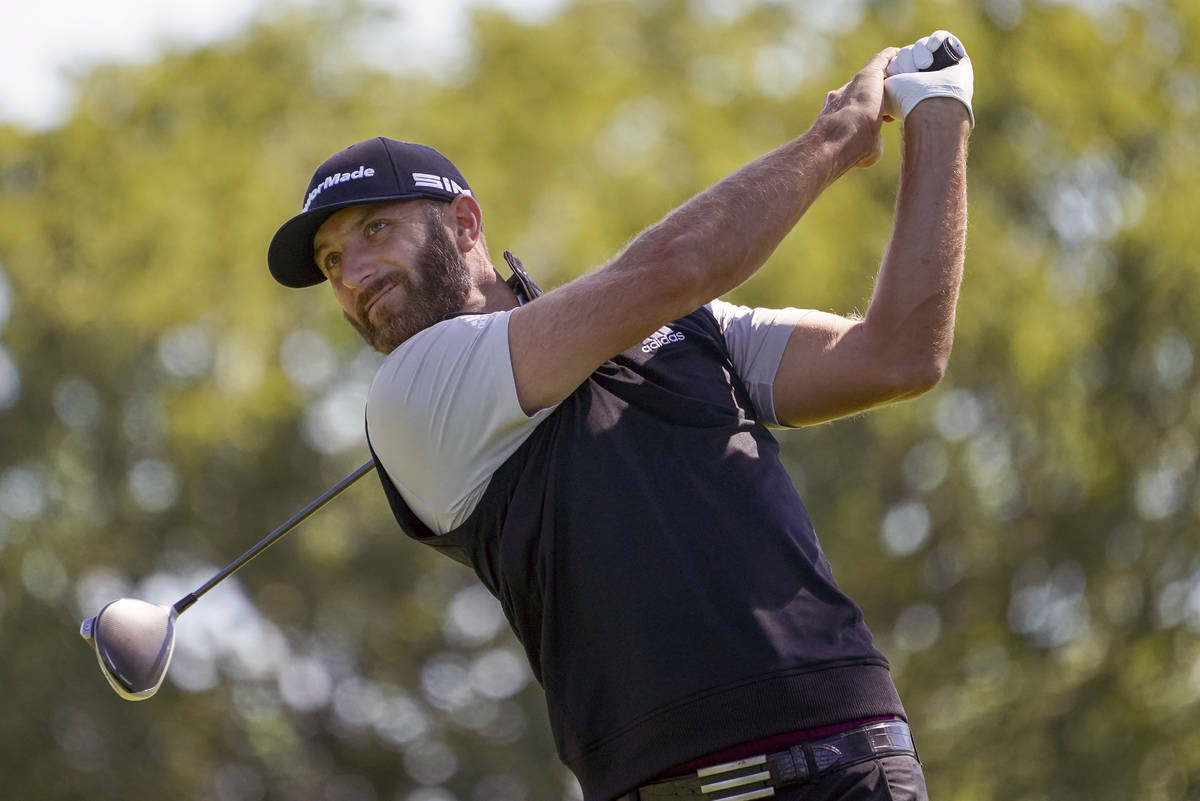 In this Saturday, Sept. 19, 2020, file photo, Dustin Johnson hits from the fourth tee during th ...