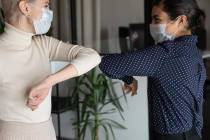 Because of the COVID-19 pandemic, social distancing, face masks, optional elbow bumps and other ...
