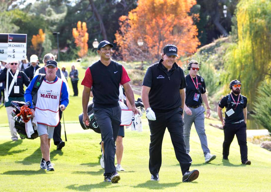 In this Nov. 23, 2018, file photo,Tiger Woods, left, and Phil Mickelson walk to the fairway aft ...