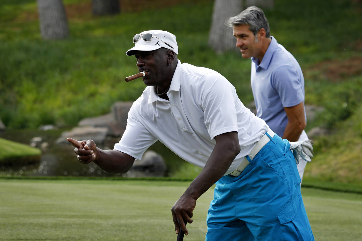 In this April 4, 2013, file photo, Michael Jordan reacts after sinking a put during the Michael ...