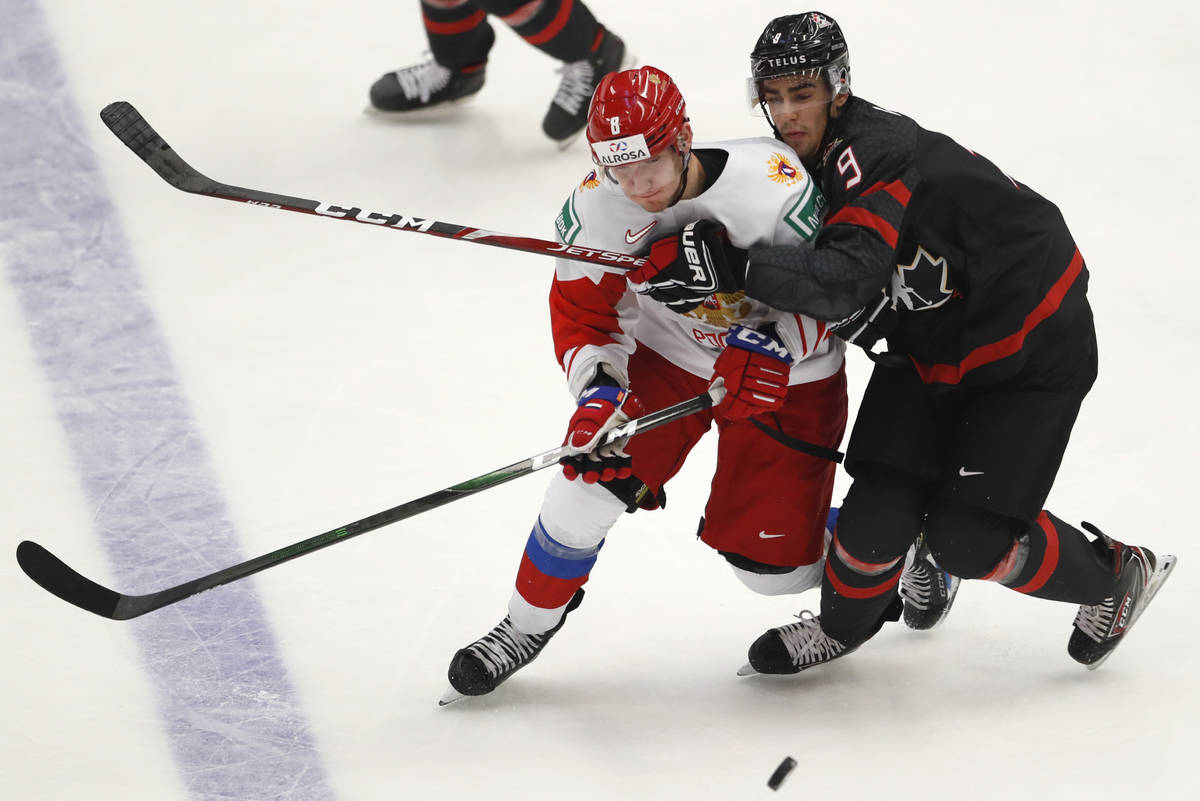 Canada's Joe Veleno, right, challenges Russia's Ivan Morozov during the U20 Ice Hockey Worlds g ...