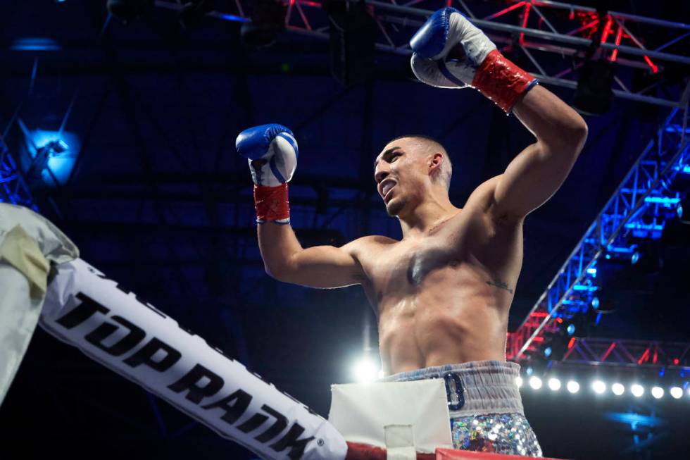 Teofimo Lopez celebrates after defeating Diego Magdaleno during a lightweight boxing match Satu ...