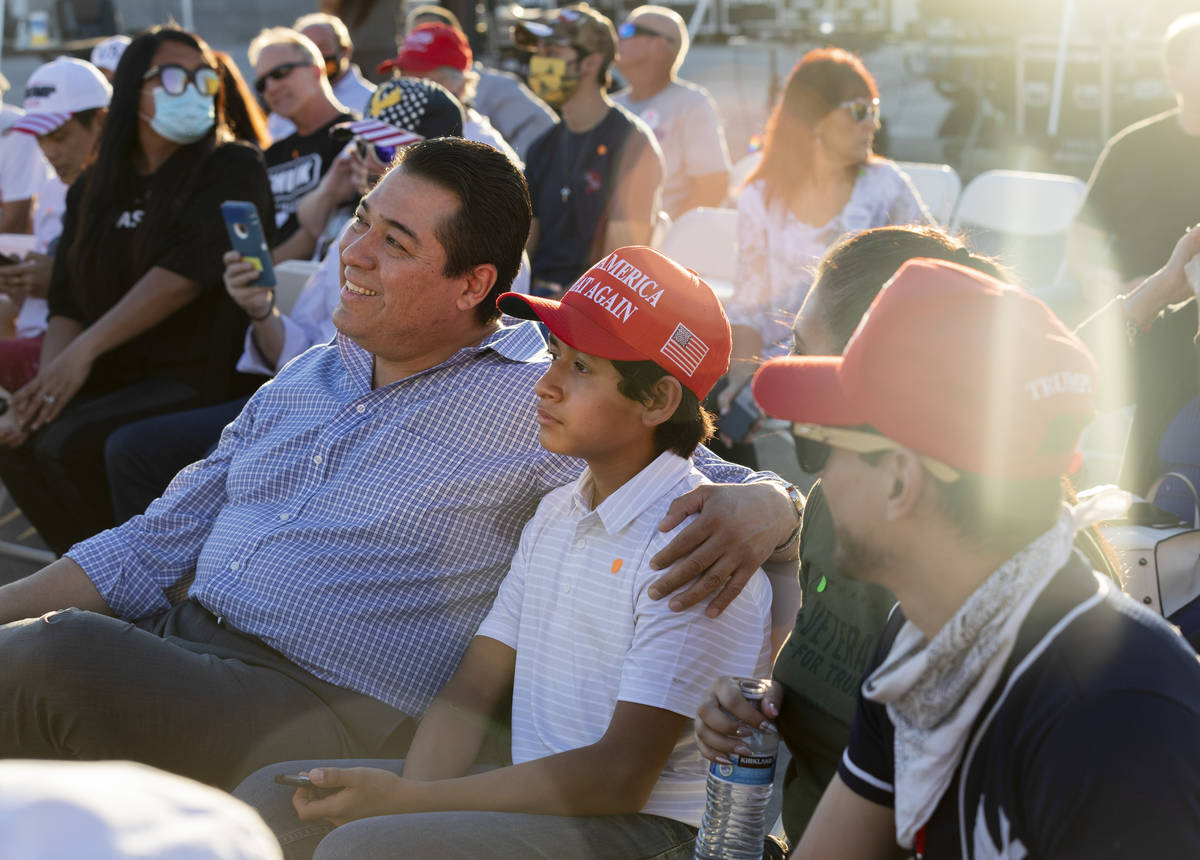 Jesus Marquez, 45, center left, and his son Jesus Marquez Jr.,12, of Las Vegas, waits for Donal ...