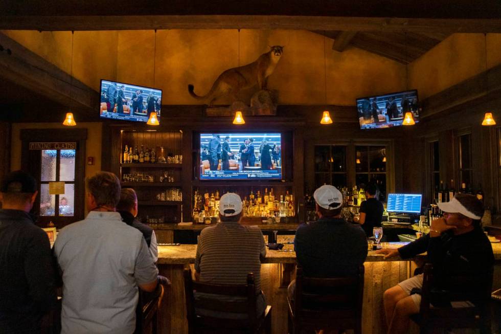 Members at Rock Creek Cattle Company watch live footage of Brendan Brisson celebrating with his ...