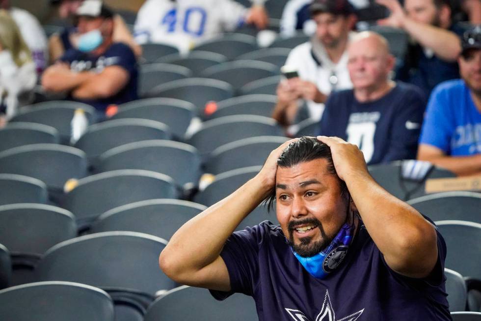 Dallas Cowboys fans Jamie Ramirez, of Amarillo, Texas, reacts after quarterback Dak Prescott wa ...