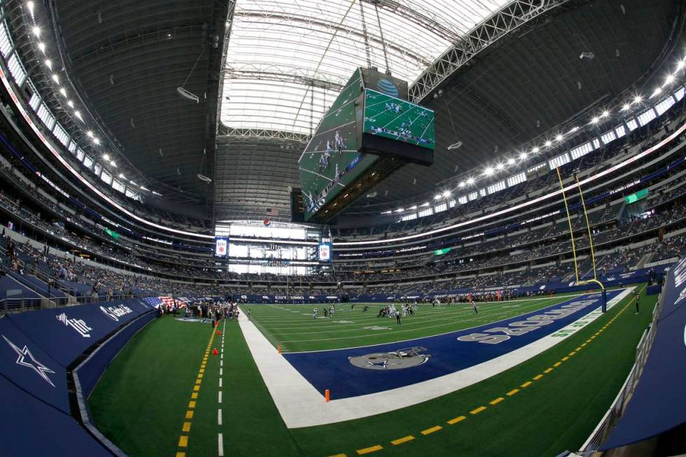 Fans watch as the Atlanta Falcons play the Dallas Cowboys at AT&T Stadium in the first half ...