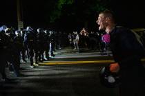 A protester screams at police as Portland protests continue. (AP Photo/Paula Bronstein)