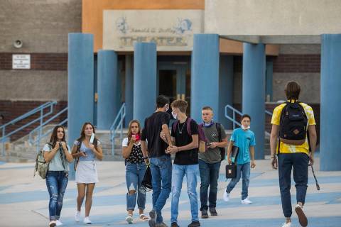 Students greet each other outside at Moapa Valley High School before the start of classes with ...