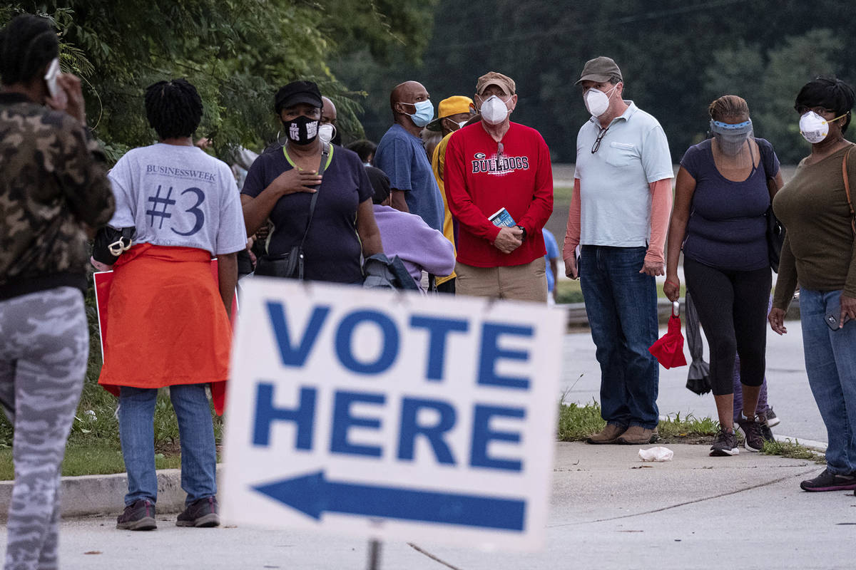People wait in line to vote in Decatur, Ga., Monday, Oct. 12, 2020. (Ben Gray/Atlanta Journal-C ...