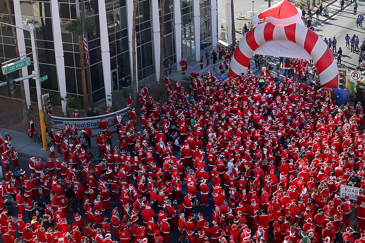 People get ready to start in the 14th annual Las Vegas Great Santa Run in downtown Las Vegas, D ...