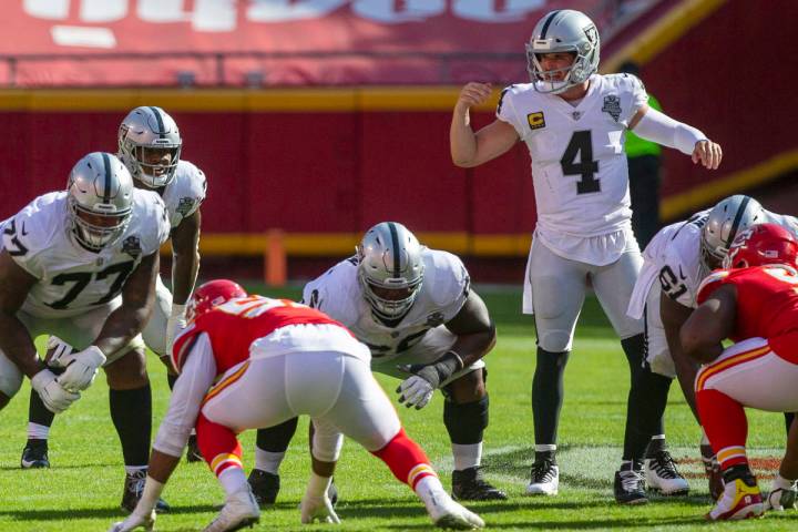 Las Vegas Raiders quarterback Derek Carr (4) audibles a play as offensive linemen Trent Brown ( ...