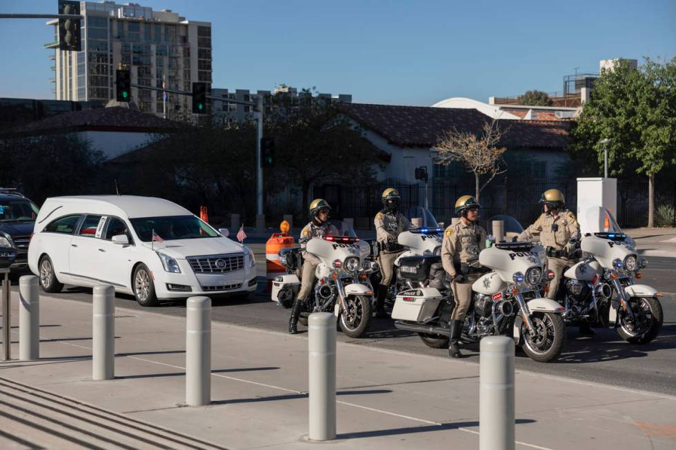 A police-escorted motorcade arrive at the front of the Lloyd D. George Federal Courthouse to ho ...