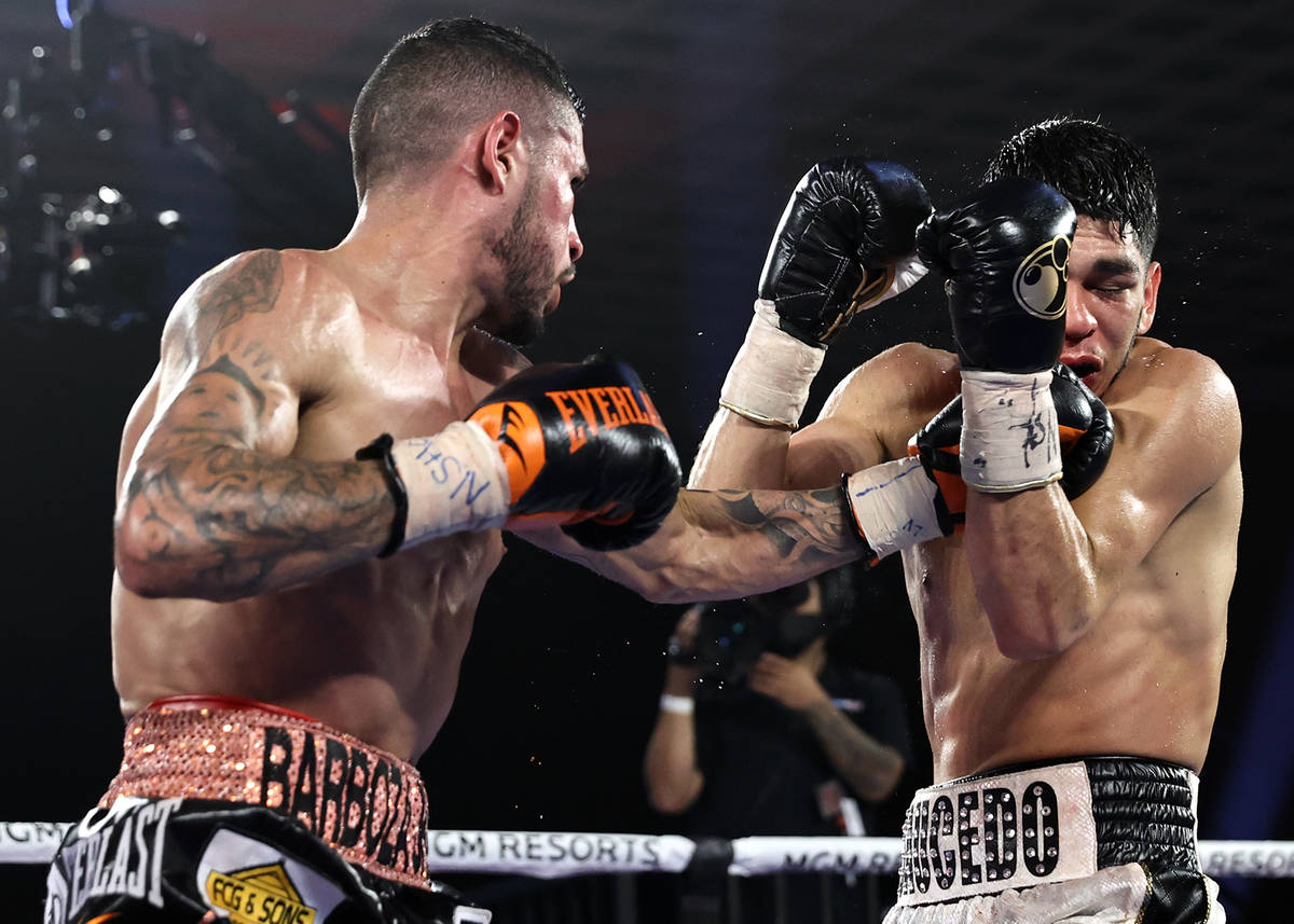 Arnold Barboza Jr., left, lands a punch against Alex Saucedo during their junior welterweight f ...