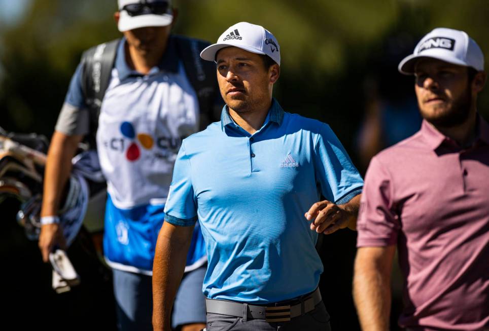Xander Schauffele walks to the fifth green alonside Tyrrell Hatton, right, during the third rou ...
