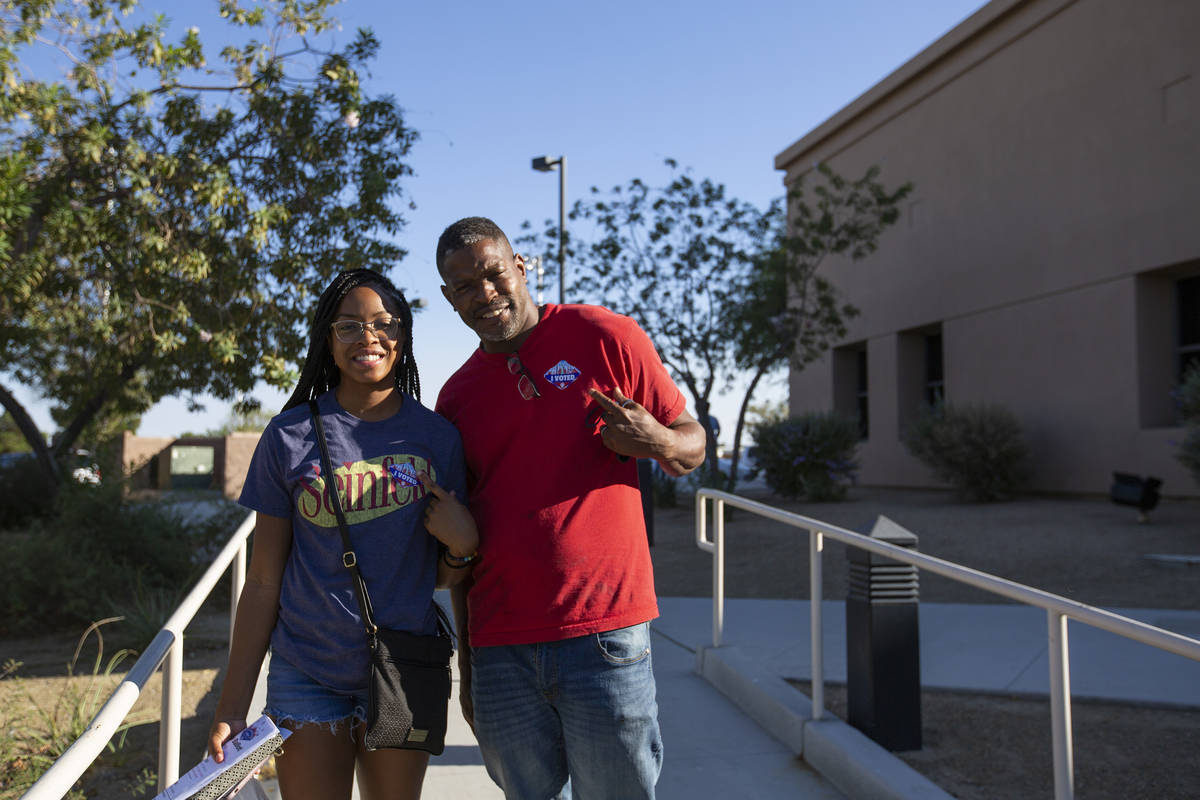 Father and daughter Larry Wilson and Tatyana Wilson poses for a portrait after voting at the Ea ...