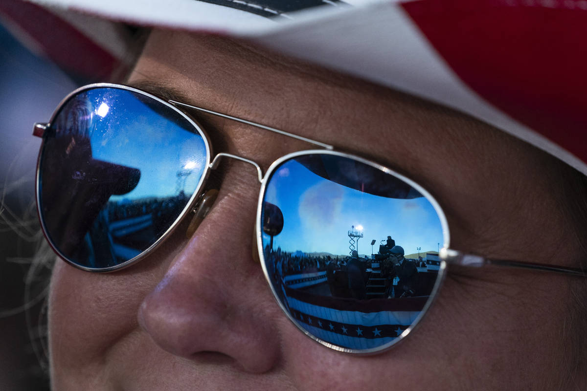 President Donald Trump is reflected in a supporter's sunglasses as he speaks at a campaign rall ...