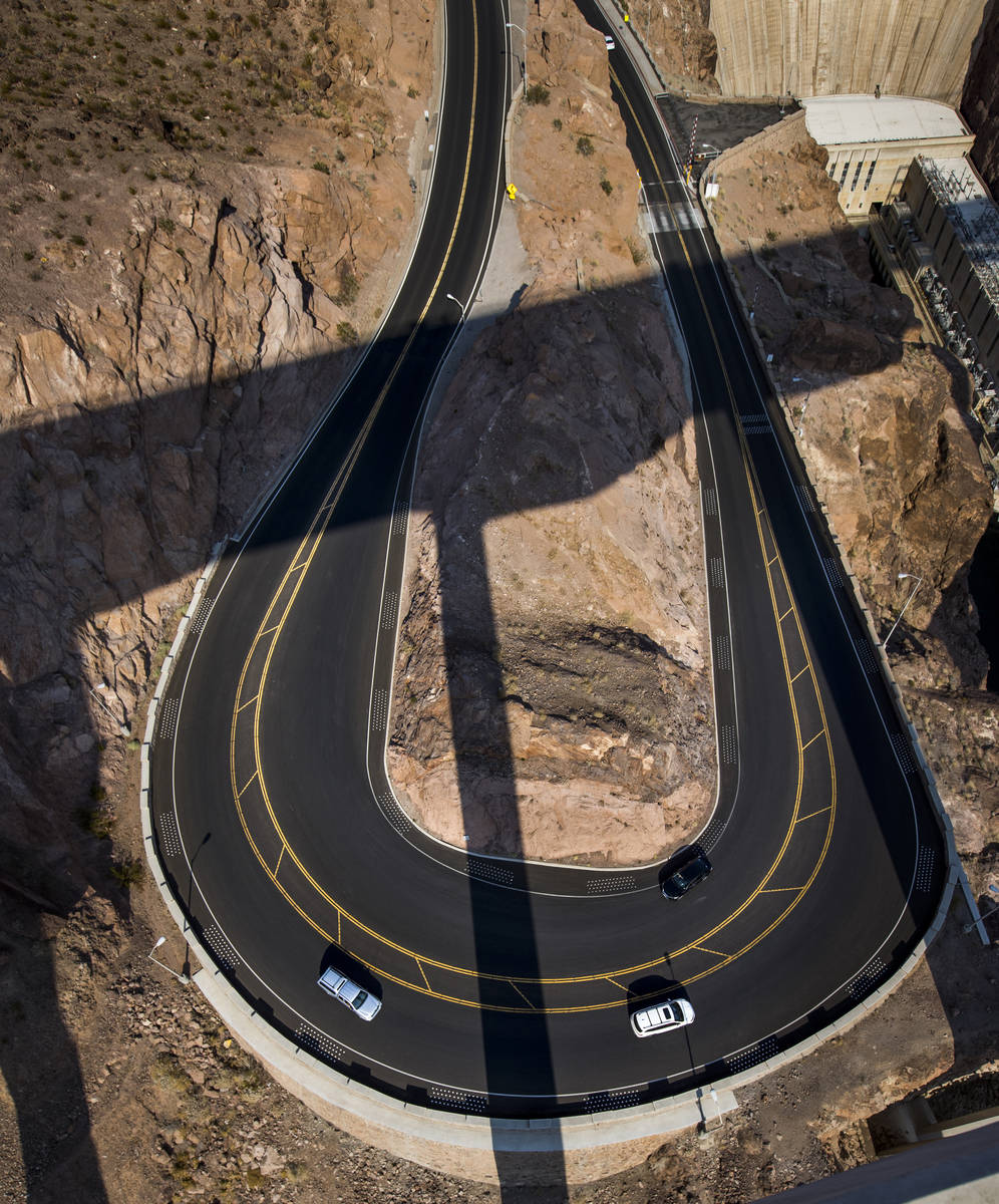 A few vehicles round the curve as Hoover Dam opens up to the public after being closed for mont ...