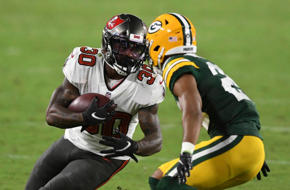 Tampa Bay Buccaneers running back Ke'Shawn Vaughn (30) runs against Green Bay Packers cornerbac ...