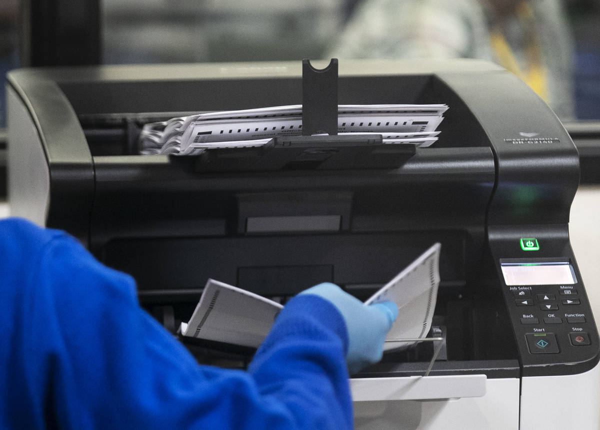 A Clark County election worker scans ballots at the Election Department warehouse, on Tuesday, ...