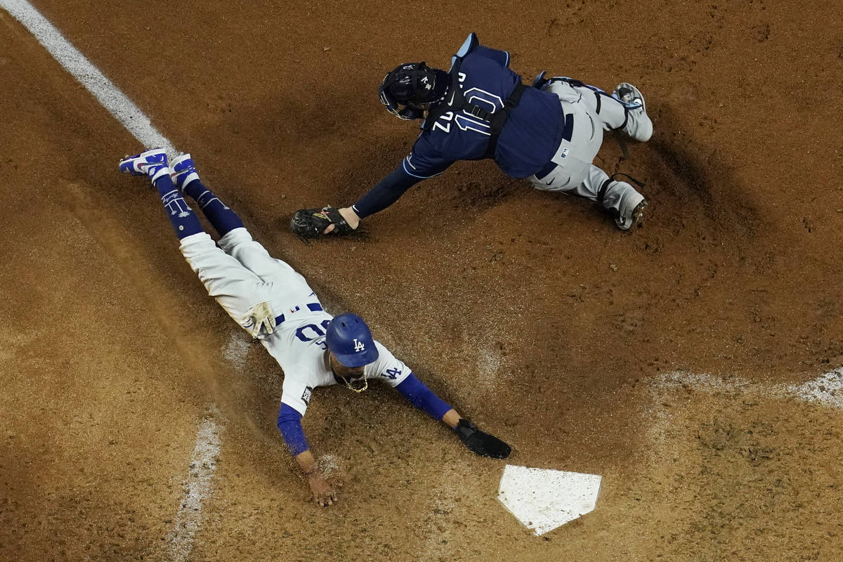 Los Angeles Dodgers' Mookie Betts scores past Tampa Bay Rays catcher Mike Zunino on a fielders ...
