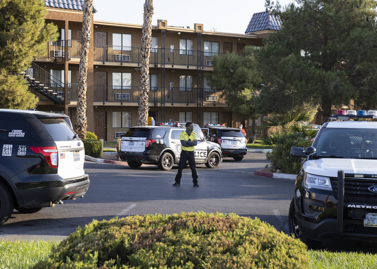 A security guard stands guard as the Metropolitan Police Department is investigating a barricad ...