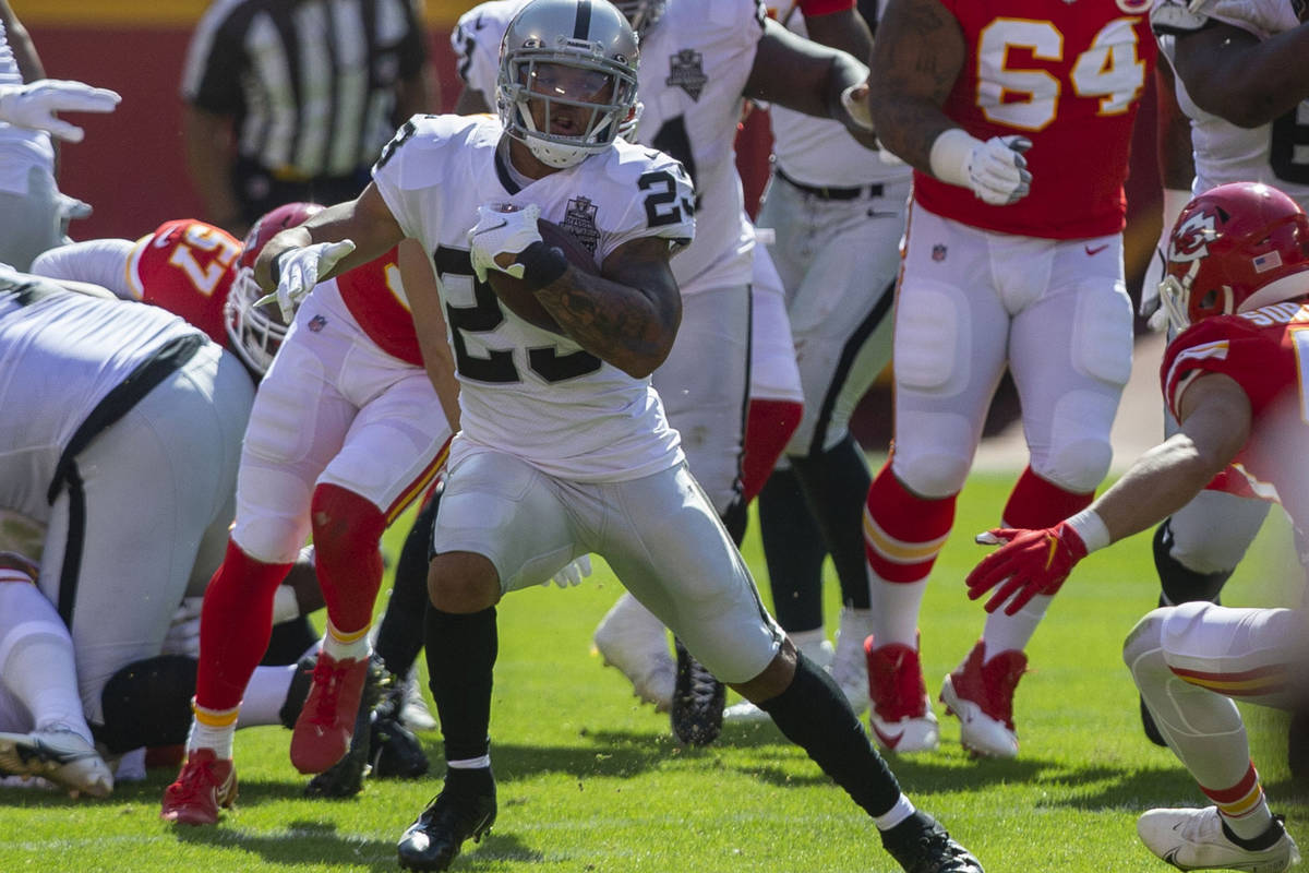 Las Vegas Raiders running back Devontae Booker (23) runs with the football against the Kansas C ...