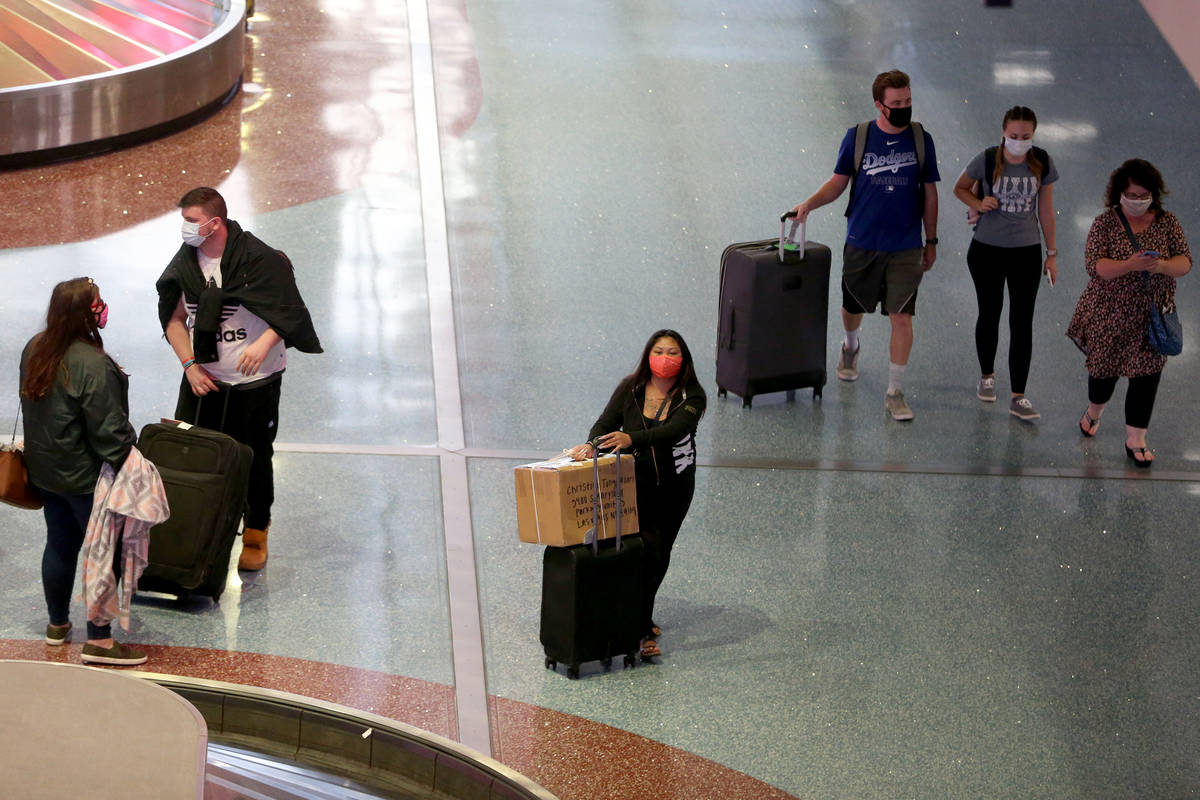 People leave baggage claim in Terminal 1 at McCarran International Airport in Las Vegas, Monday ...