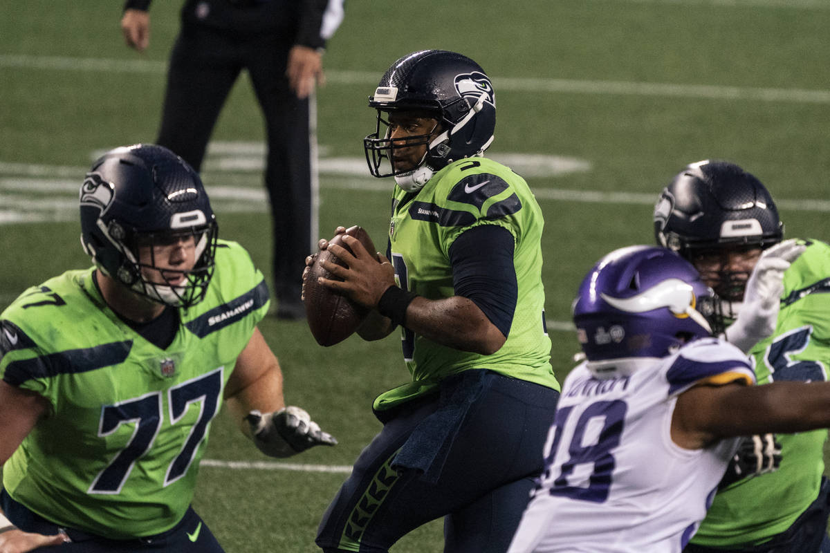 Seattle Seahawks quarterback Russell Wilson drops back to pass before throwing the game winning ...
