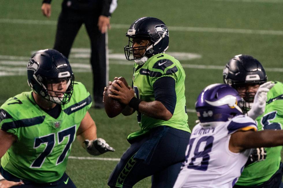 Seattle Seahawks quarterback Russell Wilson drops back to pass before throwing the game winning ...