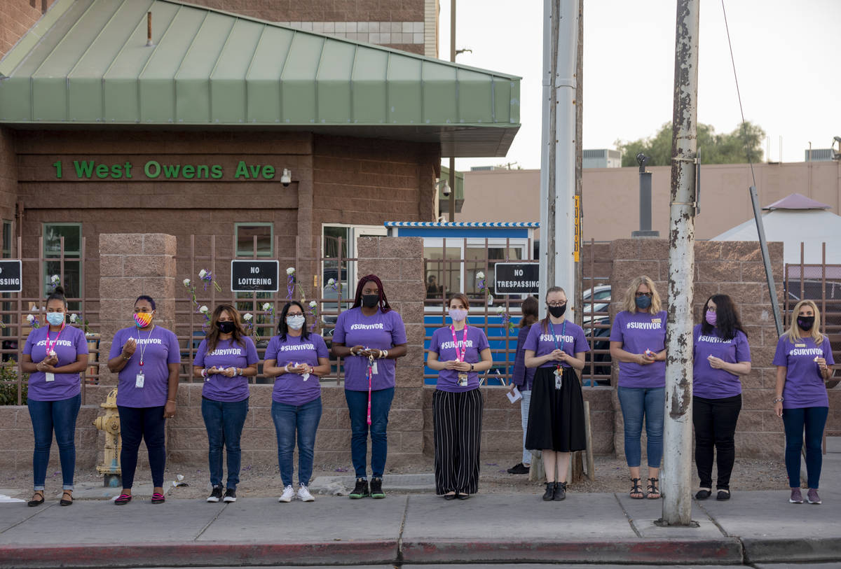 The Shade Tree staff members participate in a candlelight vigil to honor domestic violence vict ...