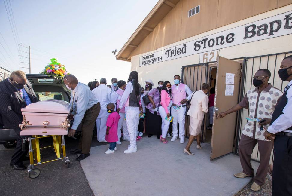 Family and friends gather outside as the casket is brought inside for the funeral service for S ...