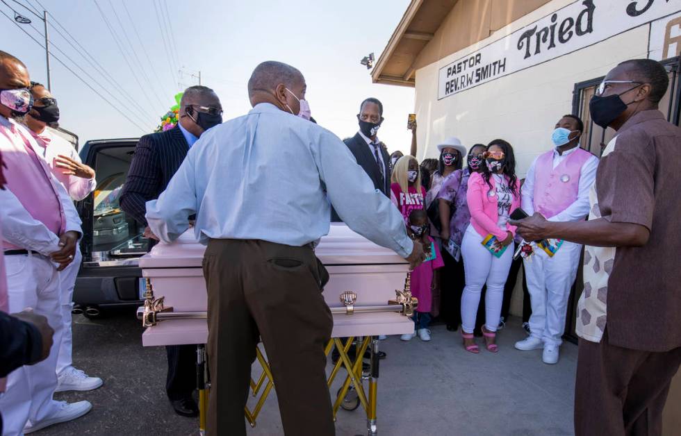 Family and friends gather outside as the casket is brought inside for the funeral service for S ...