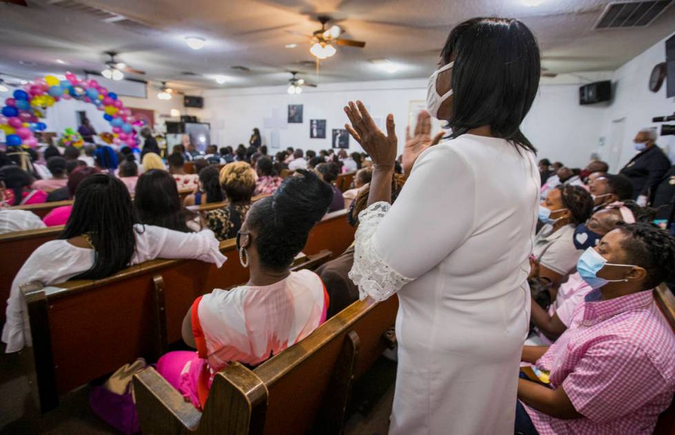 A mourner claps along to a song during the funeral service for Sayah Deal at the Tried Stone Ba ...