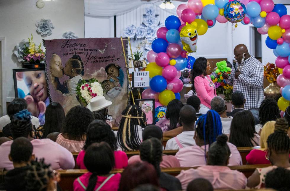 Mario Hunt, right, recites a poem he wrote for Sayah Deal to her mother Mariah Coleman during t ...