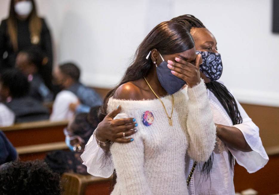 A mourner is consoled after viewing the casket during the funeral service for Sayah Deal at the ...