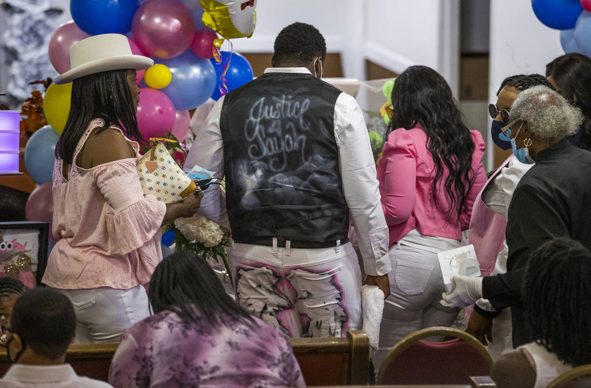 Family members gathers at the casket following the funeral service for Sayah Deal at the Tried ...