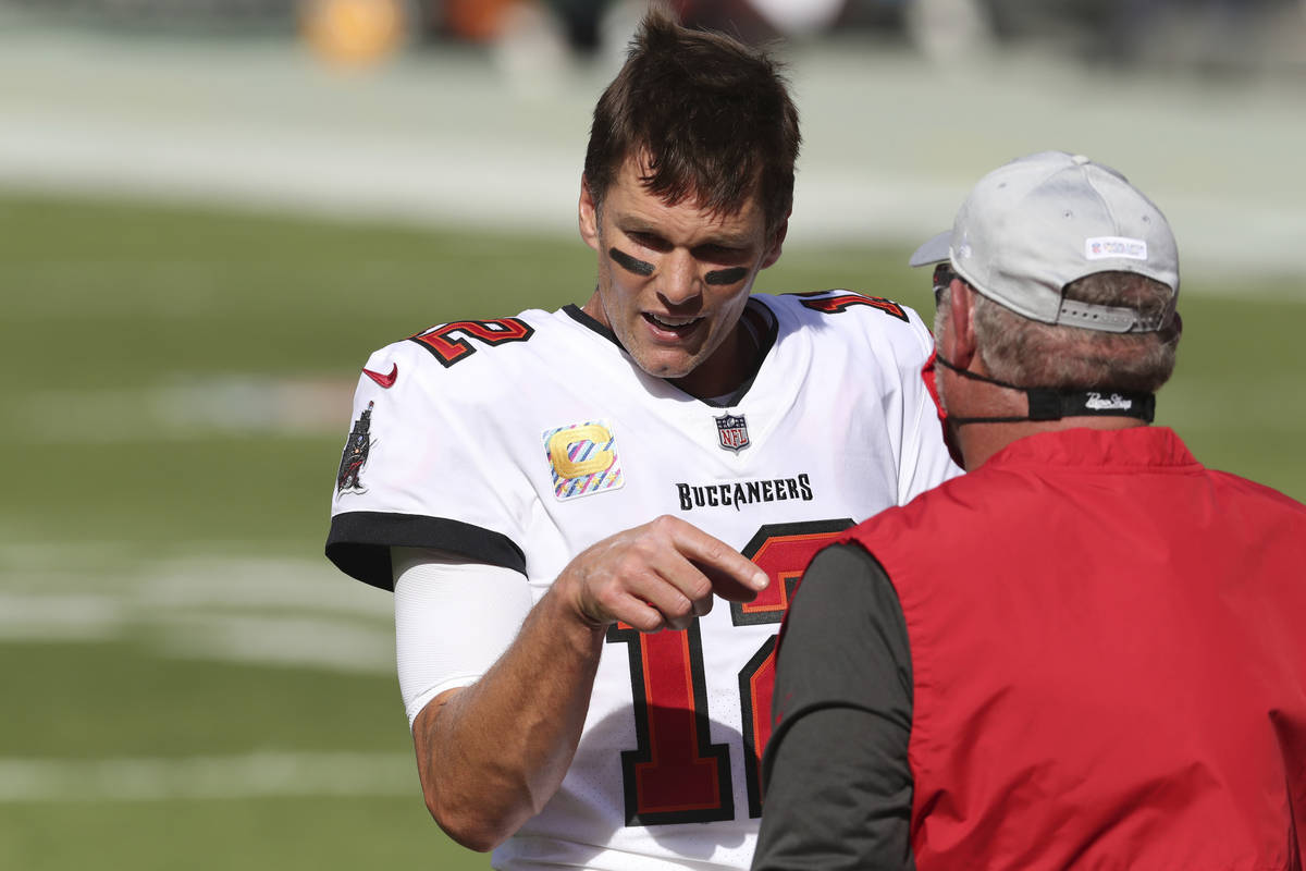 Tampa Bay Buccaneers quarterback Tom Brady (12) talks to head coach Bruce Arians before an NFL ...