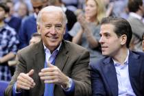 Vice President Joe Biden, left, with his son Hunter, right, talk during the Duke-Georgetown NCA ...