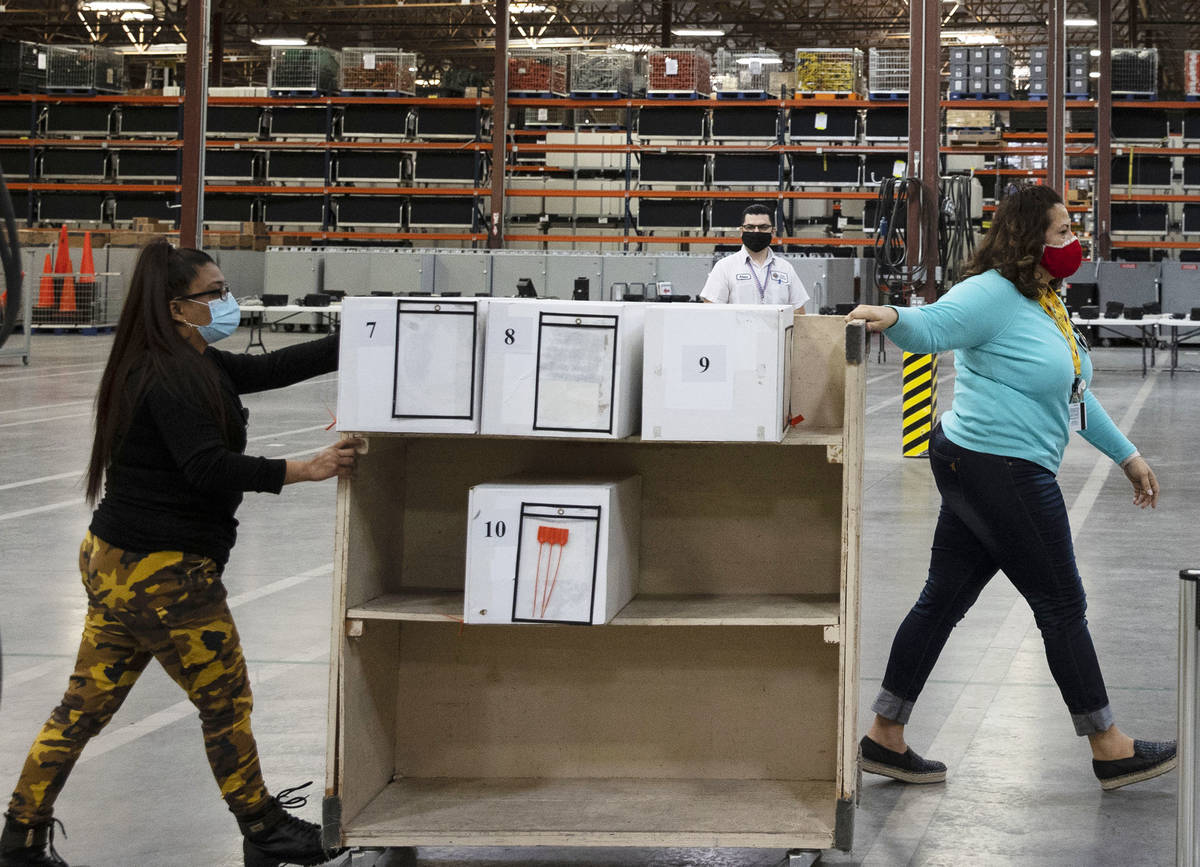 Clark County election workers deliver ballots to be counted at the Election Department warehous ...