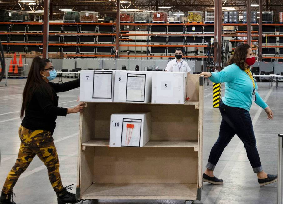 Clark County election workers deliver ballots to be counted at the Election Department warehous ...